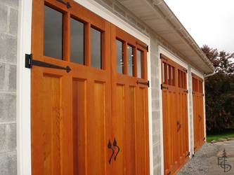 Three sets of carriage doors turn an ordinary block building into a showpiece.