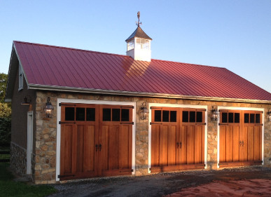 Hand made swing out carriage doors preserve historic character of carriage house