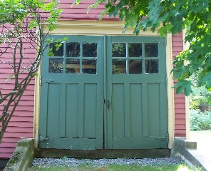 Sagging carriage door lacks proper joinery.