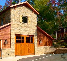 A beautiful stone barn with diagonal braced carriage barn doors.