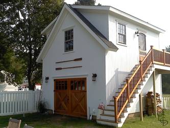 Custom 8 lite carriage doors with crossbuck braces on this shop with guest house upstairs 