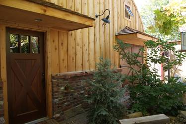 Custom entry door on a quonset hut to match it's carriage doors.