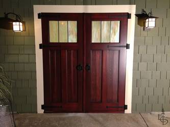 Carriage doors enhance the atmosphere of this patio entertainment space.